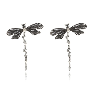 Silver dragonfly drop earrings with sparkling crystals and pearls on white background