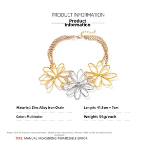 Detailed view of fashion necklace with chunky gold chains and oversized hollow flower charms