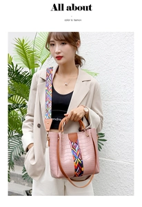 Pink crocodile pattern bucket bag with colorful geometric strap and brown handle detail
