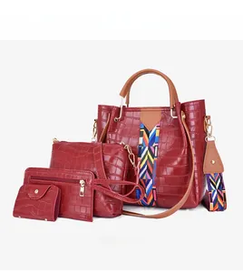 Detail view of 4-piece red handbag set with crocodile pattern and geometric strap