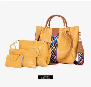 Detail of yellow crocodile pattern bag set with large tote and woven shoulder strap