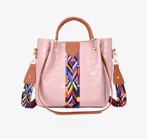 Pink faux crocodile pattern tote bag featuring an ethnic geometric woven wide shoulder strap