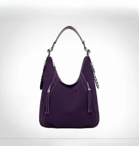Detail view of purple matte hobo bag featuring fringe tassels and silver stud strap