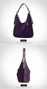Detail view of large dark purple hobo bag featuring silver rivets and tassel decorations