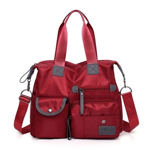 Large capacity dark red nylon travel bag with multiple pockets and adjustable strap