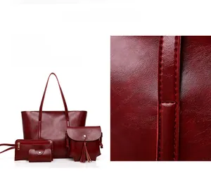 Détail d'un ensemble de sacs bordeaux 4 pièces montrant la texture du cuir ciré
