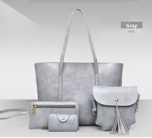 Détail d'un ensemble de 4 sacs à main en cuir gris avec cabas et finitions dorées chic