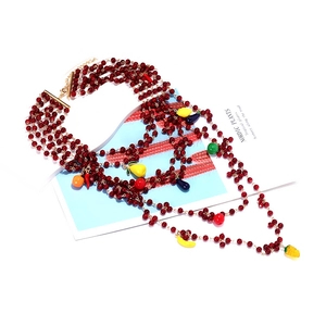 Detail of layered beaded necklace with colorful fruit charms and lobster clasp closure