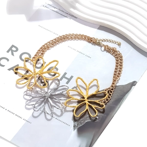 Statement necklace with oversized hollow flower pendants in mixed gold and silver finish