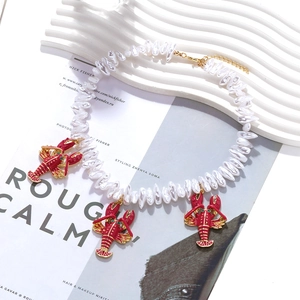 Baroque pearl necklace with red lobster enamel charms and green gemstone eyes for summer vibe
