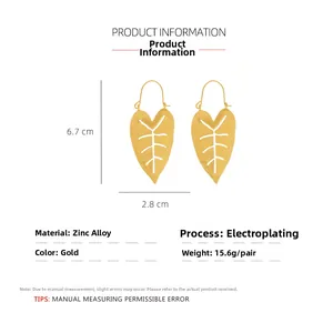 Macro view of gold monstera leaf earrings showing 6.7cm by 2.8cm size and hollow texture