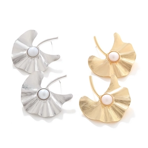 Detailed macro view of vintage gold and silver alloy ginkgo leaf earrings with pearls