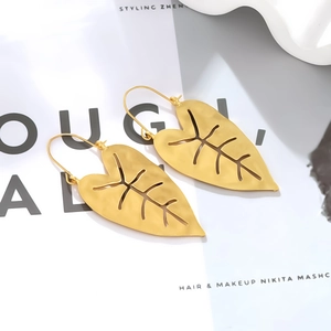 Vintage gold monstera leaf dangle earrings with hollow leaf design and matte texture finish