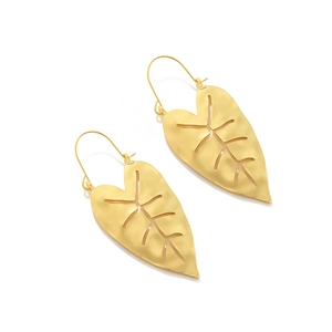Detailed macro view of gold monstera leaf earrings with hollow texture and matte finish