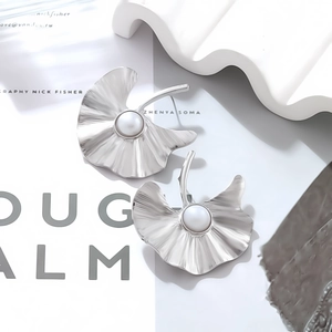 Silver ginkgo leaf drop earrings with pearl detail in minimalist textured metal design