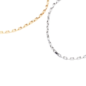 Detailed close-up of mixed gold and silver rectangular link chain necklaces