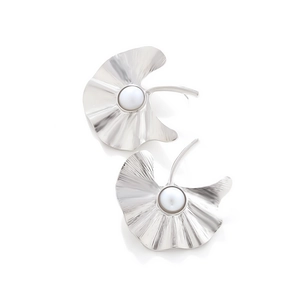 Detail of silver ginkgo leaf earrings with radial texture and a central white pearl