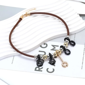 Retro geometric pendant necklace with PU leather cord and metallic beads on white display