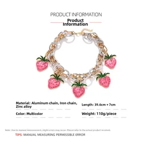 Detail of pink strawberry pendants on mixed gold and silver chunky link chain necklace
