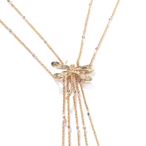 Detail of double-layer gold chain necklace featuring a dragonfly pendant and grey beads