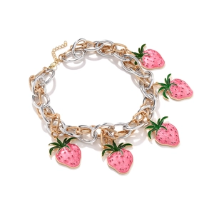 Detail of pink enamel strawberry charms on a mixed gold and silver chunky link chain