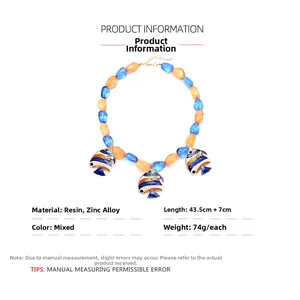 Detailed view of colorful resin beads and tropical fish charms on a collar necklace