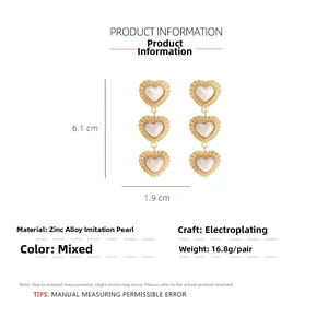 Detailed view of long heart-shaped pearl earrings showing 6.1 cm length and 1.9 cm width