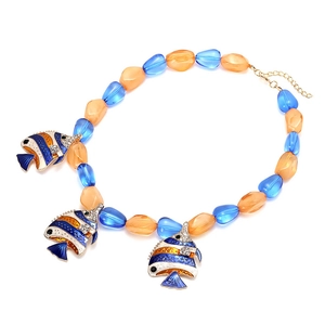 Tropical beaded necklace with orange and blue beads and three fish pendants on white background