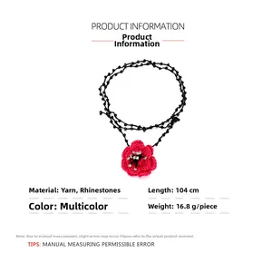 Detail of handmade crochet red camellia flower necklace with white rhinestone center