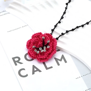 Handmade crochet camellia necklace with rose red petals and crystal on a black chain