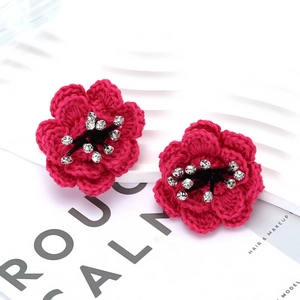 Handcrafted layered camellia flower stud earrings in vibrant fuchsia knit with crystal centers