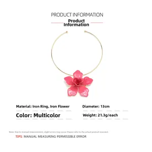 Detail view of pink metal flower pendant on golden choker with product specifications
