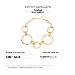 Detailed specs of chunky gold mixed link chain necklace with irregular round circle clasp