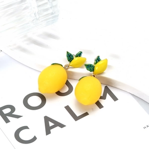 Fresh lemon drop earrings with yellow enamel and green rhinestone leaves in gold finish