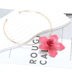 Exaggerated golden metal choker featuring a large pink enamel flower pendant for women