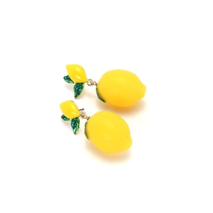 Lemon fruit earrings with yellow textured resin and green leaf details set on white background