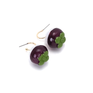 Macro shot of purple mangosteen fruit earrings featuring realistic white pulp and green leaves
