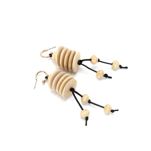Handmade bohemian earrings with spiral wood beads and tassels on a white background
