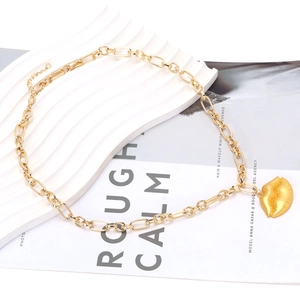 Detail of vintage gold lip pendant on a thick curb chain with lobster clasp and extender