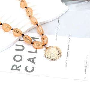 Exaggerated beach style shell pendant necklace with amber jelly beads and golden accents