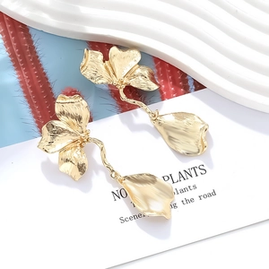 Vintage gold long flower earrings with brushed metal texture and dangling leaf petals