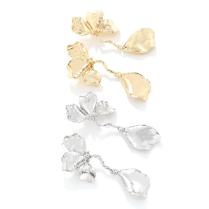 Detail of vintage textured metal flower earrings in gold and silver leaf finishes