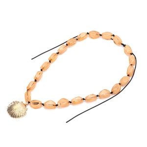 Exaggerated orange resin bead necklace with a golden shell pendant on black cord