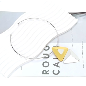 Minimalist alloy geometric choker with yellow and silver triangle pendant on white display