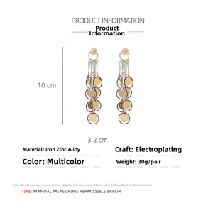 Detailed view of gold and silver metallic fringed earrings with size and material info