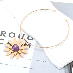 Statement gold choker necklace featuring a large 3D sunflower pendant with purple center