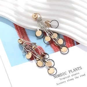 Vintage long tassel earrings with golden geometric discs in a stylish layered design