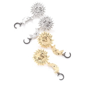 Detailed view of vintage sun and moon drop earrings with rhinestones in gold and silver