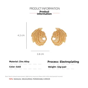 Detailed close-up of gold-plated leaf earrings with textured zinc alloy dimensions