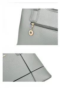 Détail du sac à main en cuir gris avec quincaillerie dorée et coutures de précision